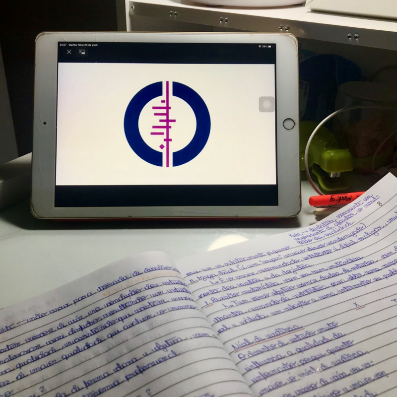 Image of a table with a tablet with the Cochrane logo and a notebook with writing in it