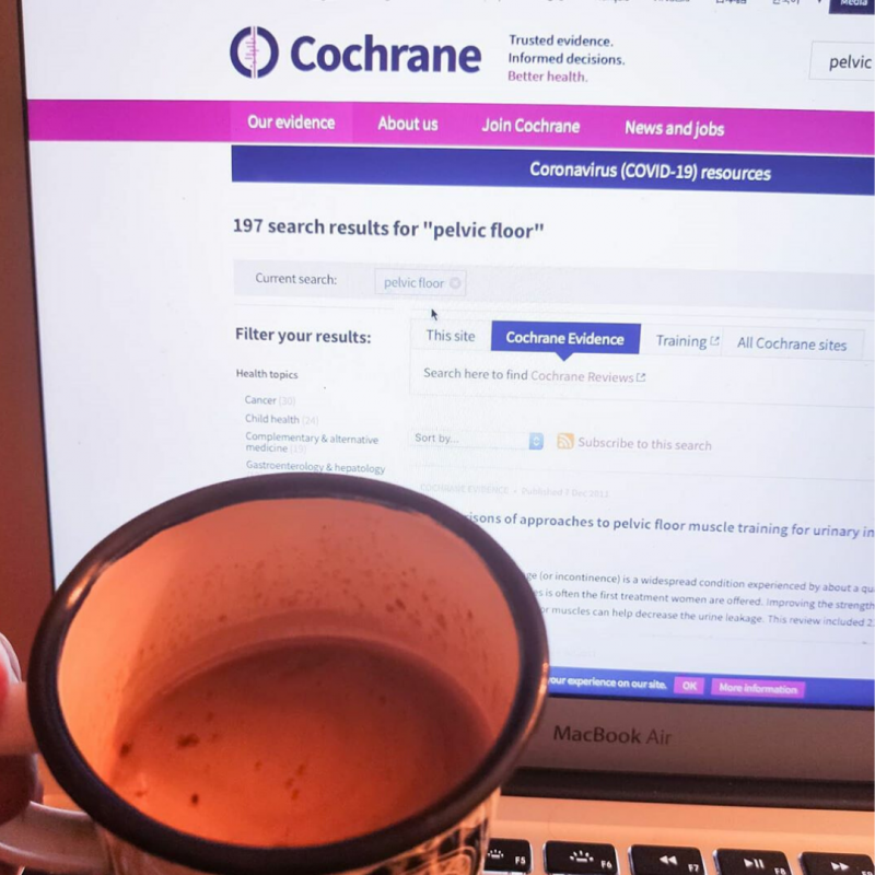 Picture of a computer screen with Cochrane Library on it, and a mug of coffee 