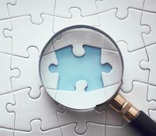 Image of a magnifying glass looking at a missing puzzle piece