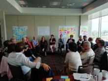 Cochrane's Governing Board members sit in a circle during a meeting