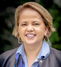 An image of Karla Soares-Weiser, who looks at the camera and is smiling