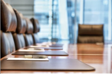 A picture of board room chairs and a table.  