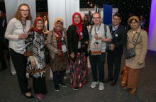 A group of people stand in a line and smile