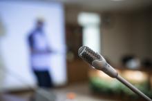 A microphone in the foreground with a blurred background