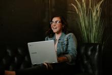 woman with a laptop who is smiling
