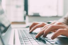 hands typing on a keyboard