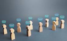 wooden avatars with comment boxes over their heads