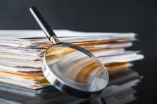 photo of a stack of pictures and a magnifying glass