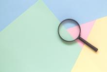 magnifying glass on a colorful background
