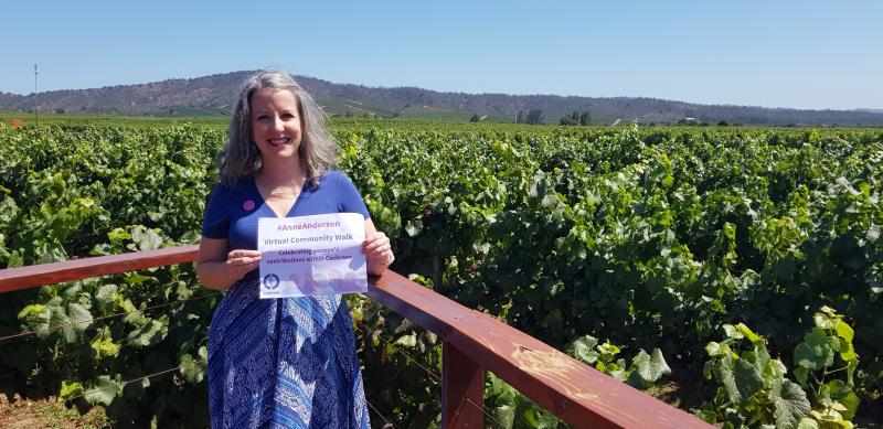 Rachel stands on a deck overlooking a vineyard in Casablanca, Chile