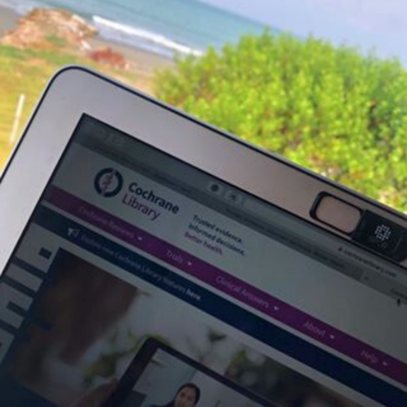 Picture of a computer screen with a beach and ocean view in the background