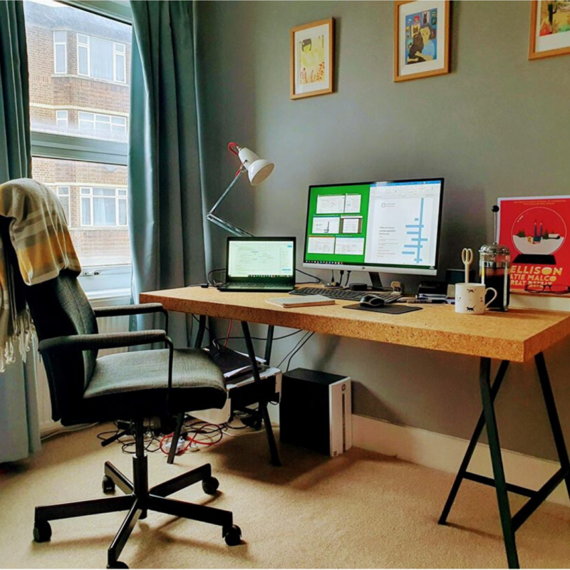 Photo of a desk and chair with a blanket over it