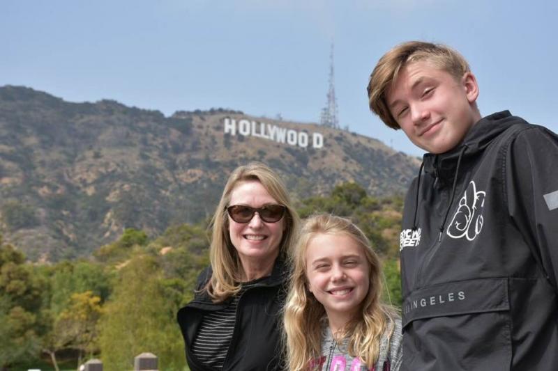 Marguerite Koster stands with grand-niece and -nephew on a hike in the Hollywood Hills in California