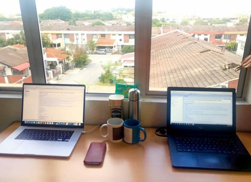 Image of table with two computers overlooking city view