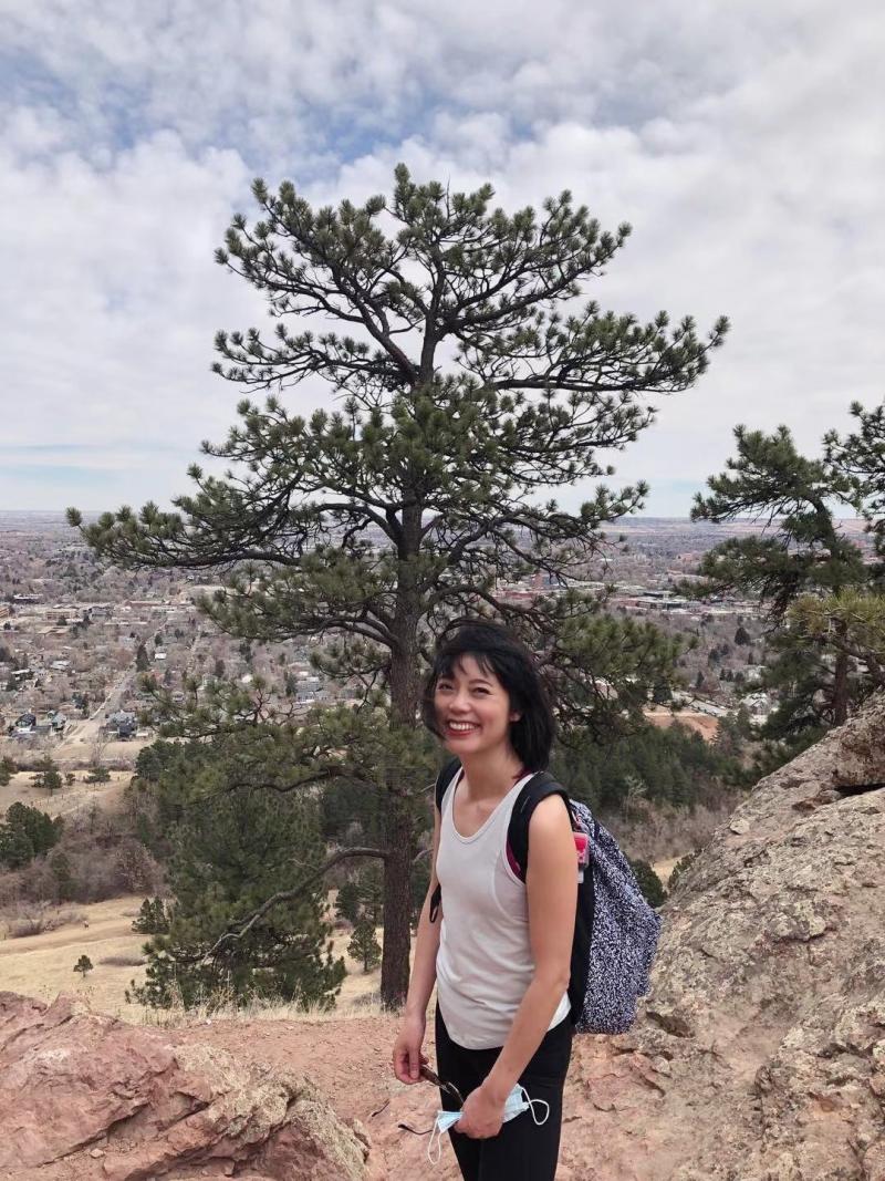 Tianjing stands on hills over Boulder, Colorado